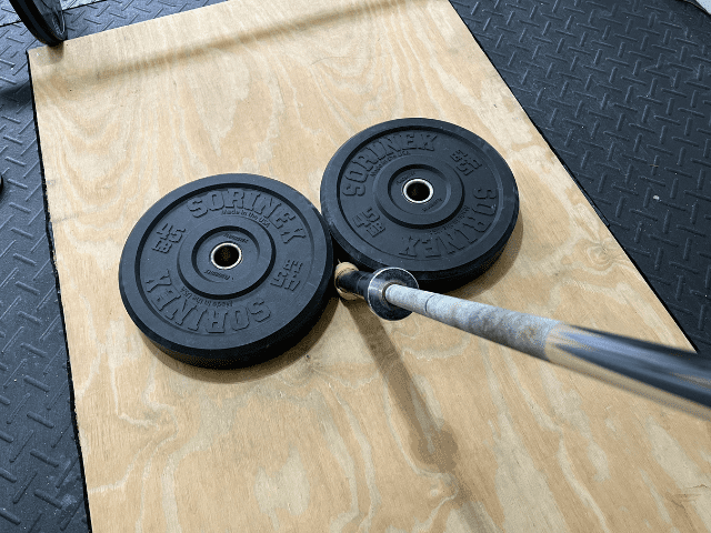 Barbell Wedged Between Bumper Plates