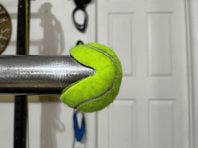 Closeup of Tennis Ball on Barbell