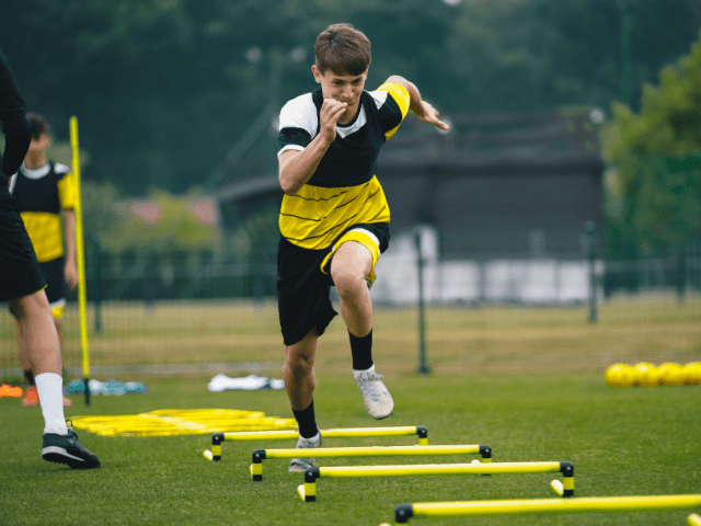 Soccer Player Doing Low Hurdle Sprints